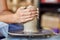 Creating jar or vase of clay. Woman hands, potter`s wheel