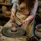 Creating a jar or vase Master crock. The sculptor in workshop makes jug out of earthenware closeup