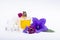 Creation of perfume essence, summer flowers sweet light fragrance, perfume bottle and colorful aromatic flowers isolated