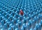 Creative abstract individuality, uniqueness and leadership business concept: single red 3D people figure in crowded group of blue