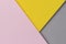 Creative abstract yellow, pink and gray color geometric paper compositon background, top view