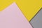 Creative abstract yellow, pink and gray color geometric paper compositon background, top view