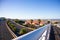 Creative angle from white metal railings on the bridge of Nelson Mandela Boulevard.