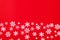Creative arrangement of christmas decoration snowflakes on red background. Holiday concept. Flat lay, top view