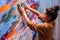 Creative artist painting with fingers