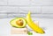 Creative avocado, banana and micro green balance wooden stands and podiums., white background, Equilibrium healthy food