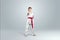 Creative background, baby in white kimono on a light background. The concept of martial arts, karate, sports since