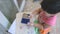 Creative boy using stamper with blue ink and stamp on paper as artwork from high angle view