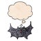 A creative cartoon happy vampire bat and thought bubble in grunge texture pattern style