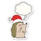 A creative cartoon hedgehog wearing christmas hat and thought bubble as a printed sticker