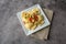 Creative cheese ravioli topped with fresh tomato and avocado and seasoning.