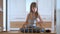 Creative child girl playing with game stacking wooden toy blocks in high building structure. Hand movement control and