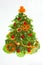 Creative christmas tree made of vegetables isolated on white