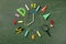Creative clock face from colorful school supplies on blackboard top view and flat lay. Back to school and time to study concept