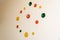 Creative clock in the form of multi-colored circles on the wall