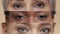 Creative collage of diverse ladies eyes looking at camera, posing over beige studio background, slow motion