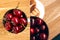 Creative collage. Red, ripe, bright cherries on a wooden background