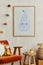 Creative composition of cozy scandinavian child`s room interior with mock up poster frame, red armchair, plush toys.