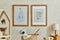 Creative composition of cozy scandinavian child`s room interior with two mock up poster frames, rattan basket, lamp, plush.