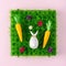 Creative composition with egg wrapped in a paper in the shape of a bunny with a carrots. Easter minimal background. Spring