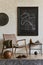 Creative composition of elegant masculine living room interior design with mock up poster frame, brown armchair, industrial shelf.