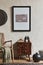 Creative composition of elegant masculine room interior with mock up poster frame, brown armchair, designed commode and personal.