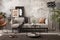 Creative composition of indiustral and loft living room interior with mock up poster frame, gray sofa, round coffee table, brown