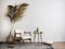 Creative composition a living room interior with copy space beige armchair, coffee table, vase with dried flowers and personal