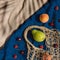 Creative composition made of fruits and mesh bag on beach towel. Summer background. Vegan and vegetarian food concept. Zero west