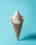 Creative composition with seashells and ice cream cone on pastel blue background. Summer minimal concept