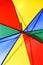 Creative concept of a bright multicolored beach umbrella closeup