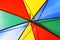 Creative concept of a bright multicolored beach umbrella closeup