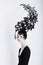 Creative Concept. Futuristic Woman in Art Fabulous Headdress