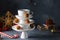 Creative concept with white dishes Christmas tree shape pyramid with cup of tea on top decorated with sweet chocolate truffles on