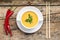 Creative cuisine. Pea Soup with chopstick on wood background