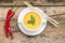 Creative cuisine. Pea Soup with chopstick on wood background