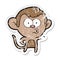 A creative distressed sticker of a cartoon pointing monkey