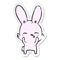 A creative distressed sticker of a curious waving bunny cartoon