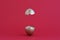 Creative Easter egg surprise concept. Golden easter egg broken in half on a red background, levitation. Copy space