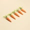 Creative Easter or spring holiday concept. Minimal festival or celebration greeting card or banner. Carrots on pastel yellow