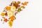 Creative fall composition with white pumpkins, fallen leaves and other floral elements, autumn decor