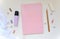 Creative feminine workplace, flatlay stationery composition, writing objects in random order lace, marker, pink notepad, paperclip