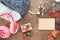 Creative flat lay of Christmas ornaments, winter accessories and craft notebook on wood background
