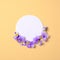 Creative flat lay composition: circle blank paper and blooming flower petals on yellow background. Top view, floral round frame,