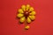 Creative flower food background. Yellow cherry tomatoes on red background top view