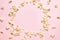 Creative food composition of tasty salted popcorn frame on a pink background