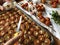 Creative food photography. Woman preparing tomatoes for roasting