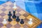 Creative foreshortening from above chess concept with wooden desk with black and white figures on game space and lay near on