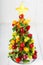 Creative fruit Christmas tree with different berries, fruits and