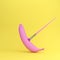 Creative fruit painted made of pink banana on yellow background.